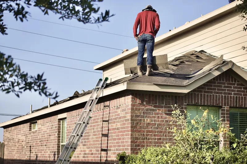 Professional roofer working on a residential roof in Flourtown
